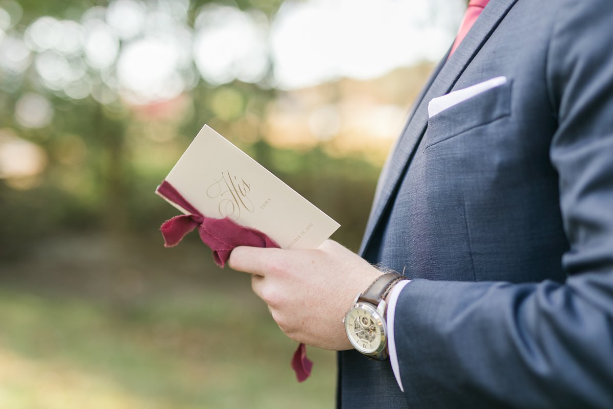 groom holding vow book